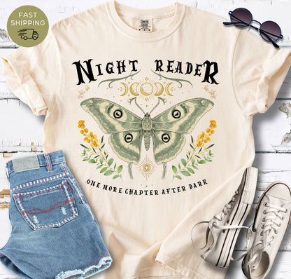 Book lover graphic tee with a large sage green moth, celestial moon details and botanical accents.
