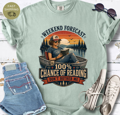 Summer reading T-shirt with a woman in sunglasses reading in a boat and the words “Don’t Bother Me.”
