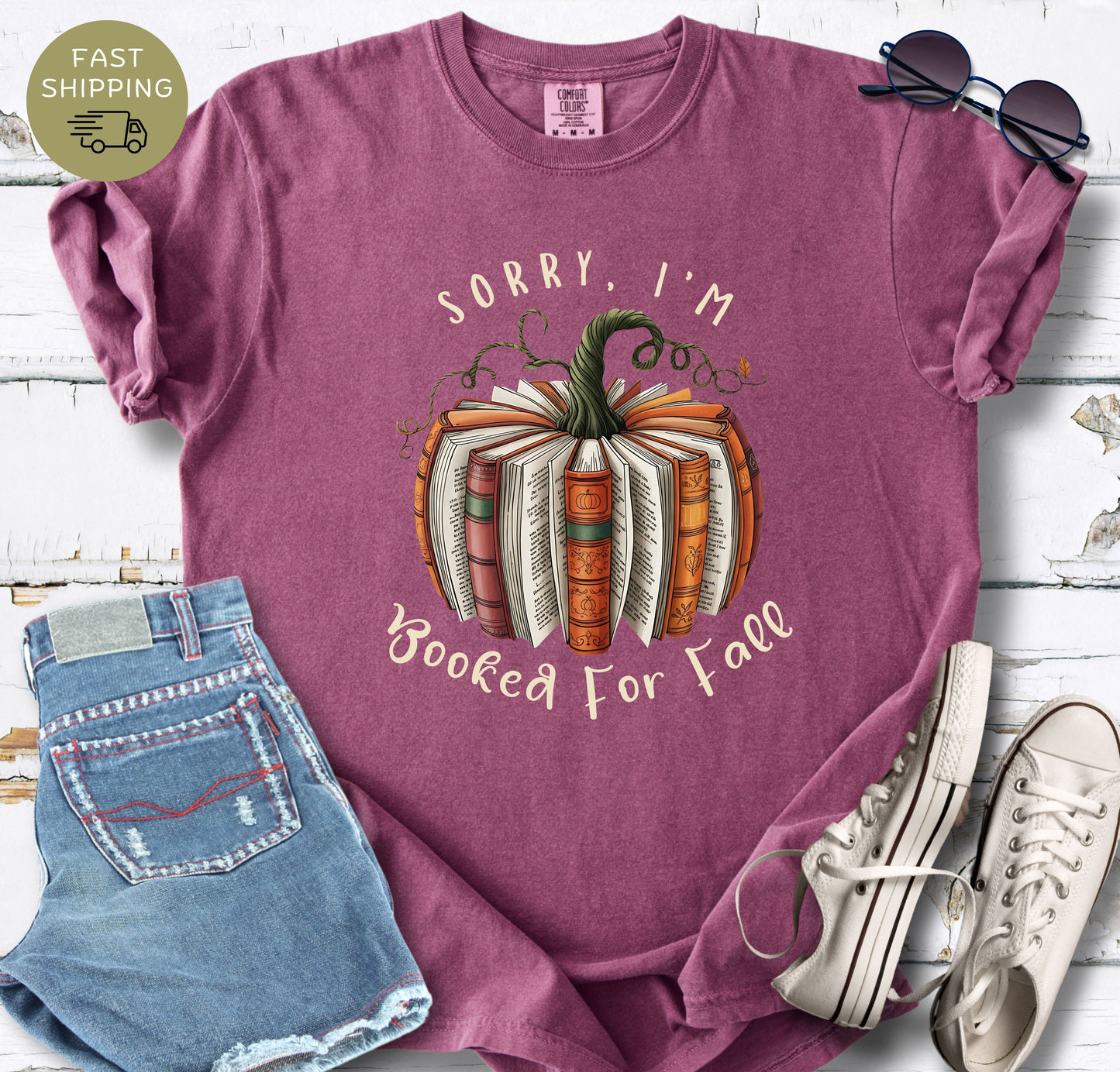 Funny fall reading shirt styled with denim shorts, white trainers, and sunglasses.