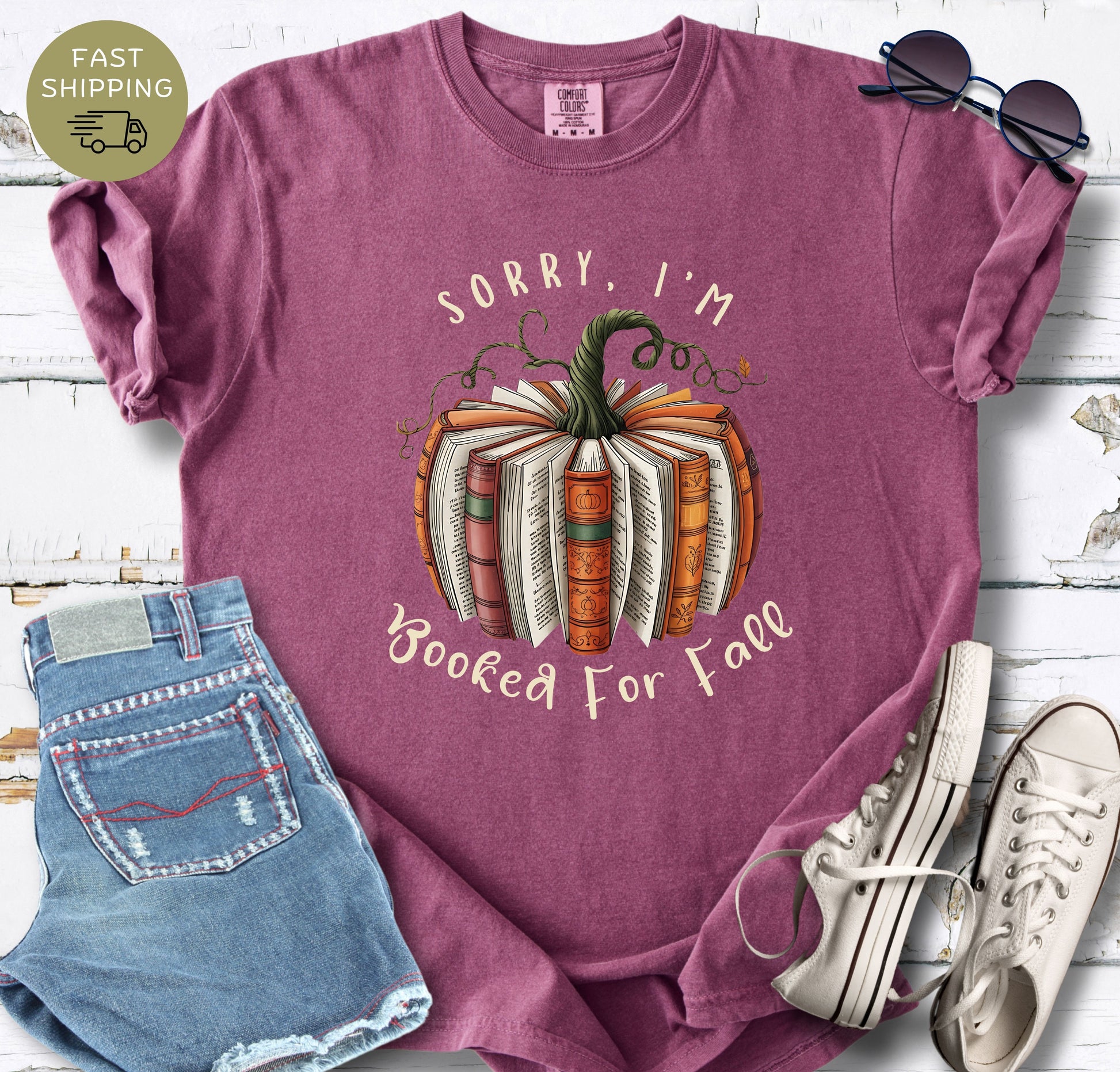 Funny fall reading shirt styled with denim shorts, white trainers, and sunglasses.