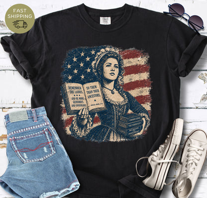 Black bookish t-shirt with a colonial woman, American flag, open book, and historic quote.