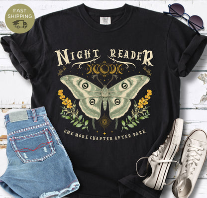 Black Comfort Colors T-shirt featuring the phrase “Night Reader” with a luna moth and moon phase design.