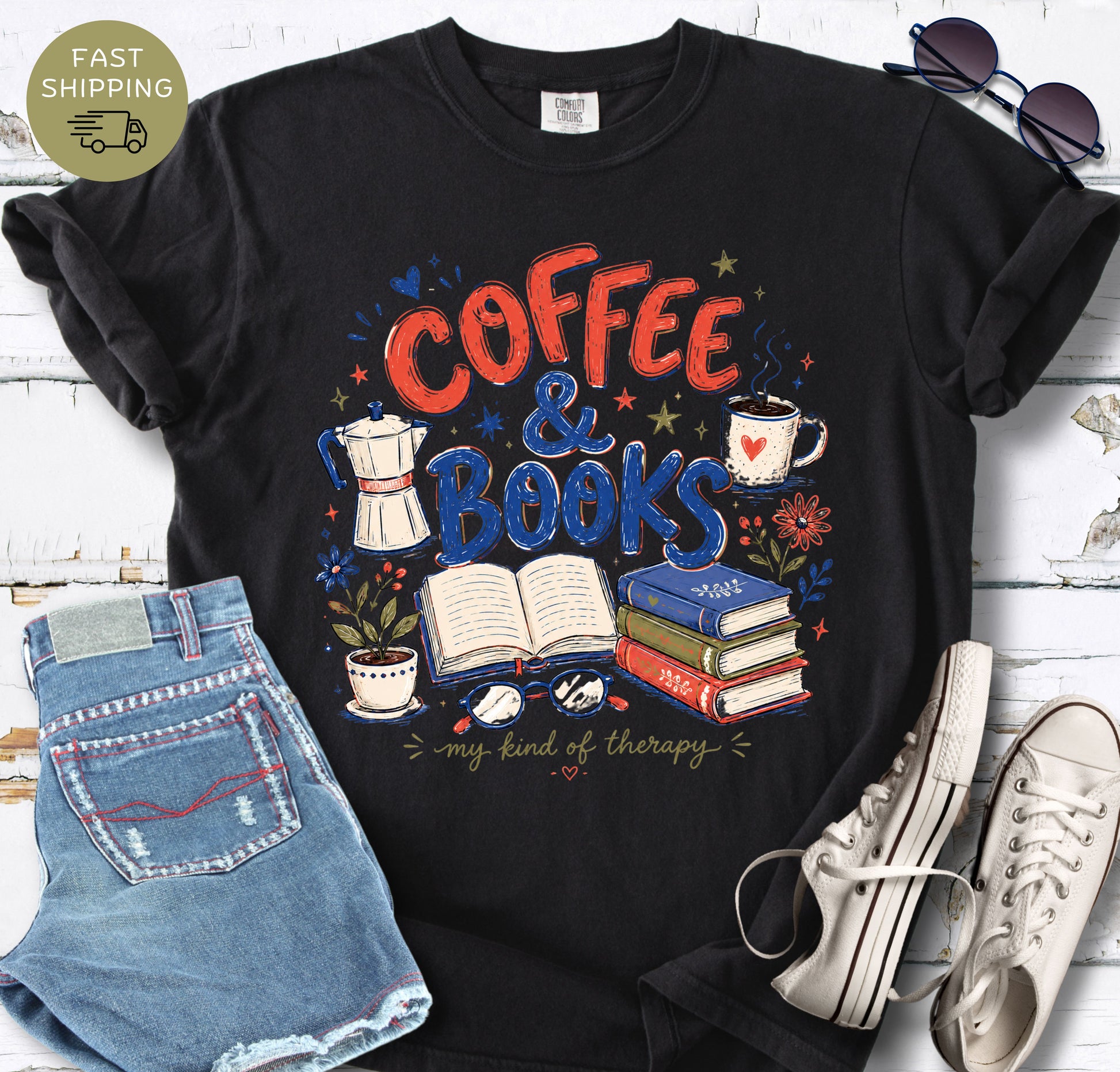 Book lover t-shirt featuring coffee cup, stacked books, open book, glasses, and flowers.
