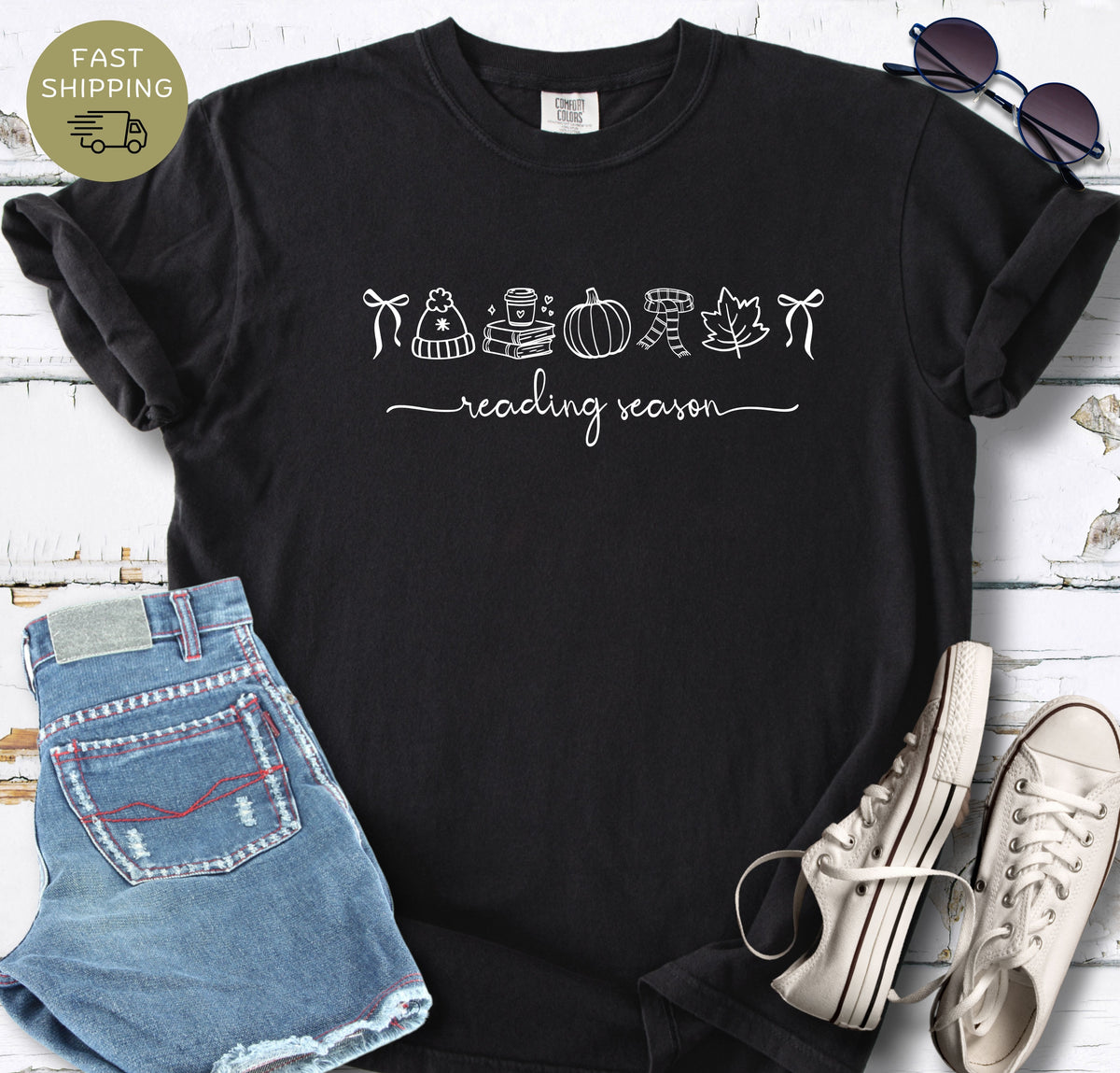 Black reader shirt with pumpkin, books, coffee cup, scarf, and leaf design.
