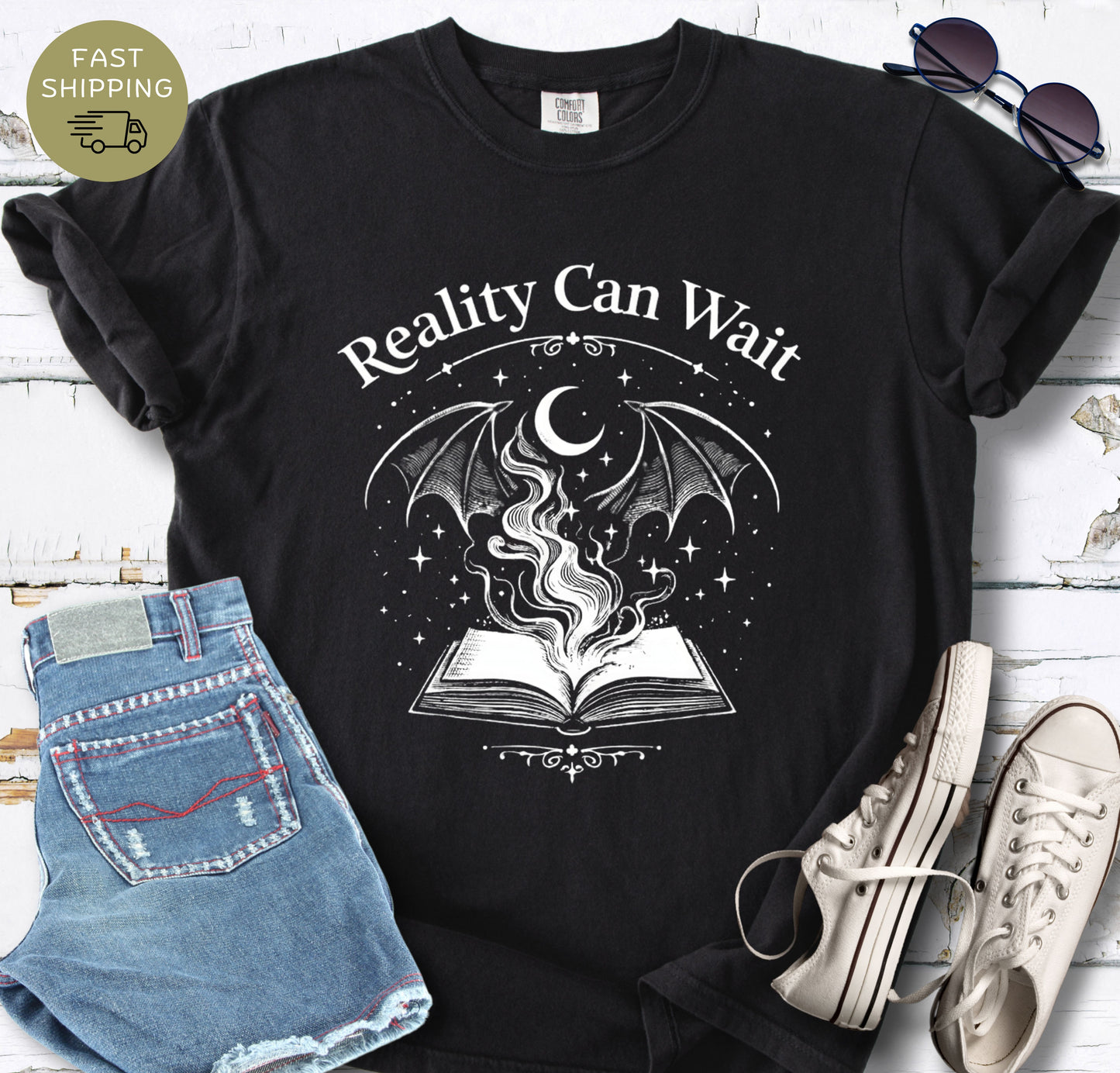 Reality Can Wait fantasy bookish t-shirt with open book and magical design on Comfort Colors 1717 black