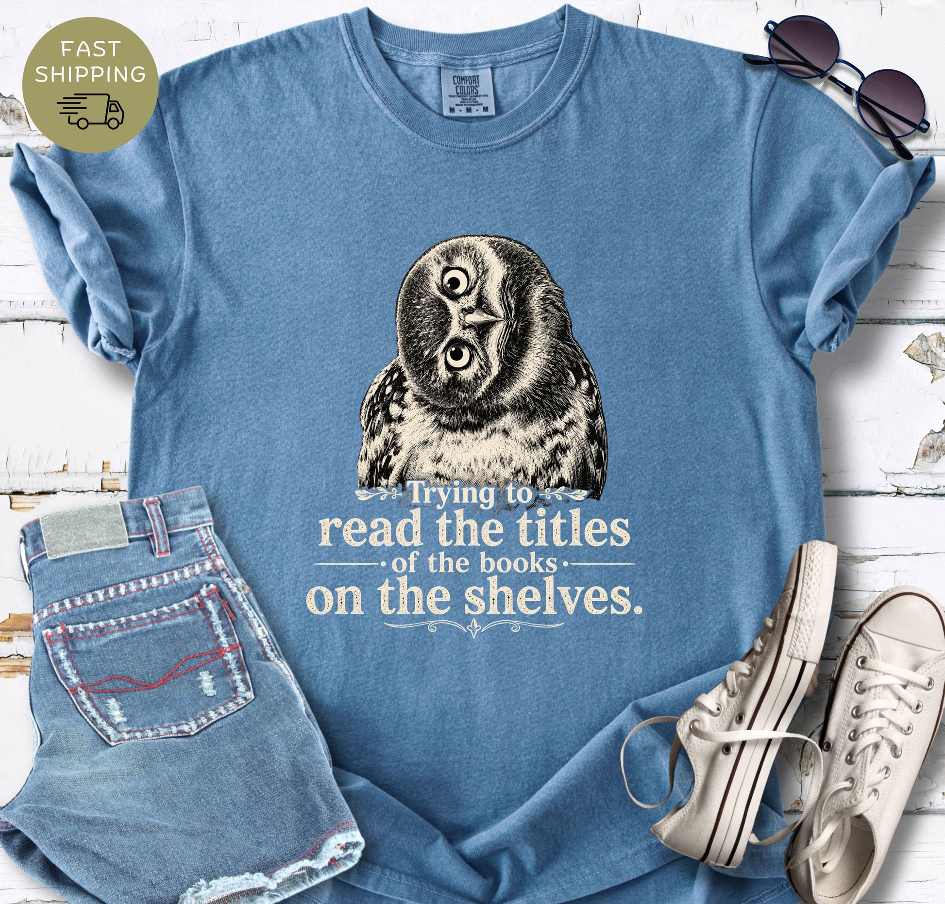 Book lover graphic tee with a detailed owl design and a funny reading quote in cream lettering.