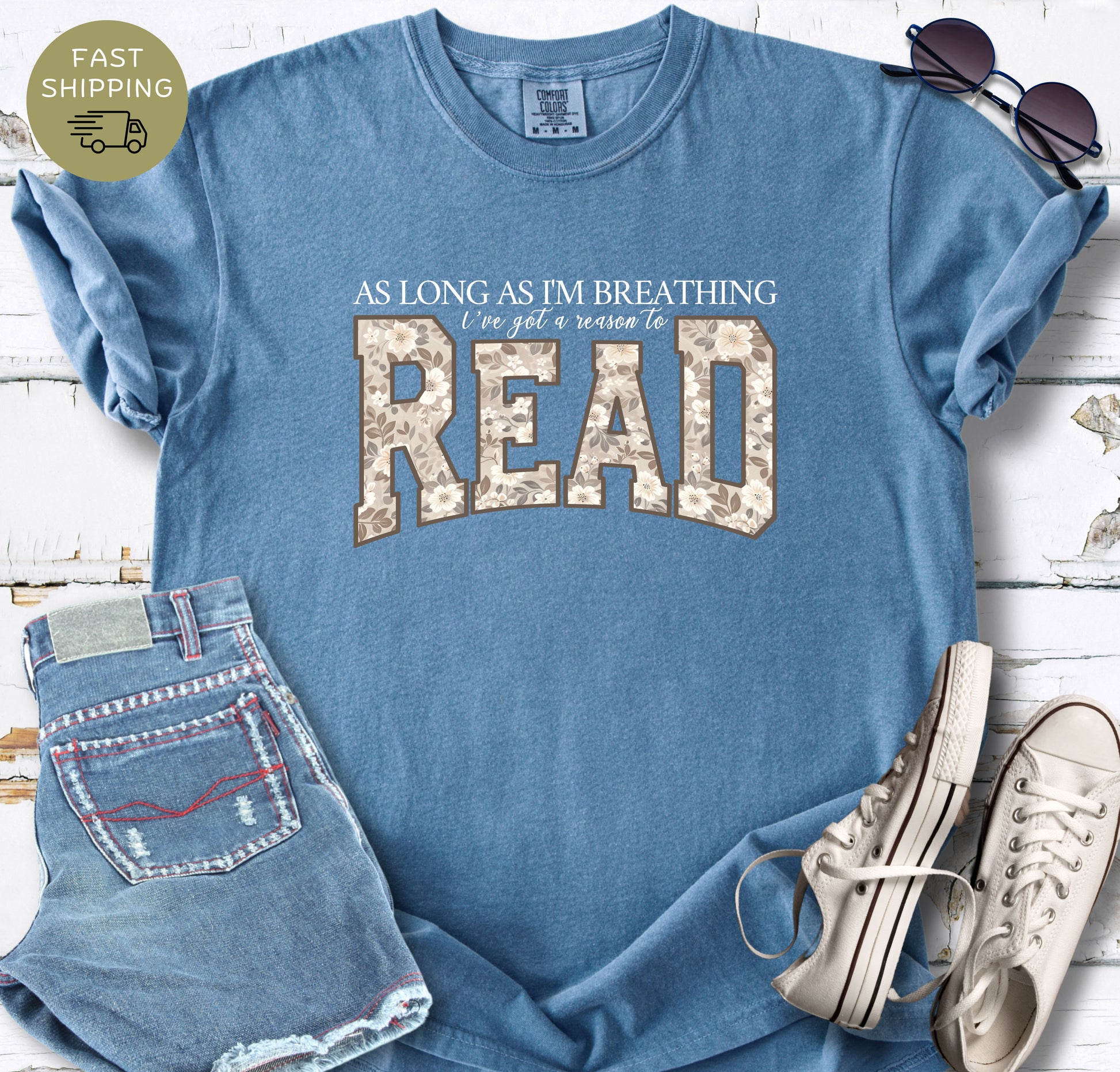 Relaxed-fit reader T-shirt with a meaningful reading quote and neutral floral typography.