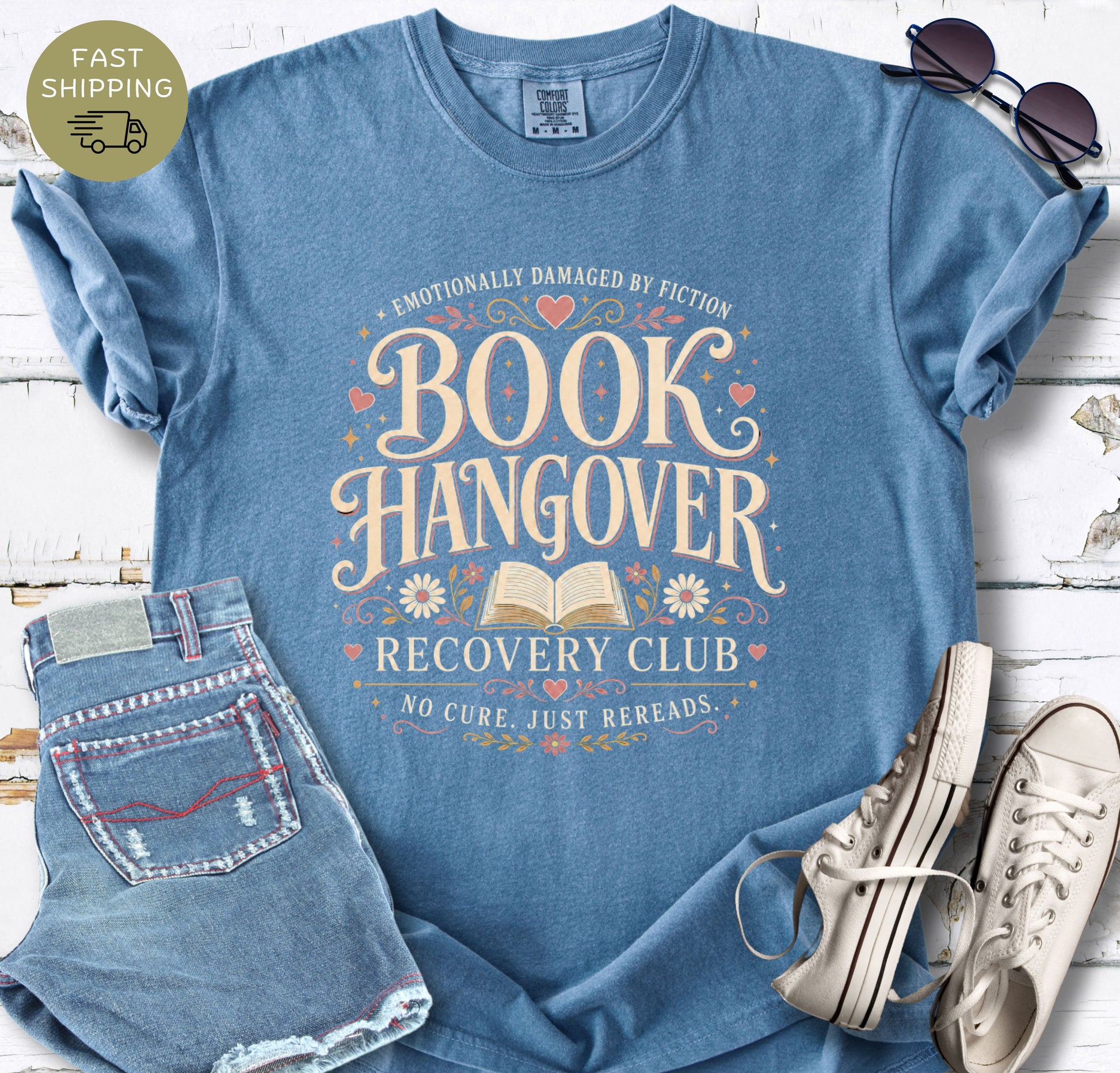 Women’s bookish T-shirt in black styled with denim shorts, sunglasses and white trainers.