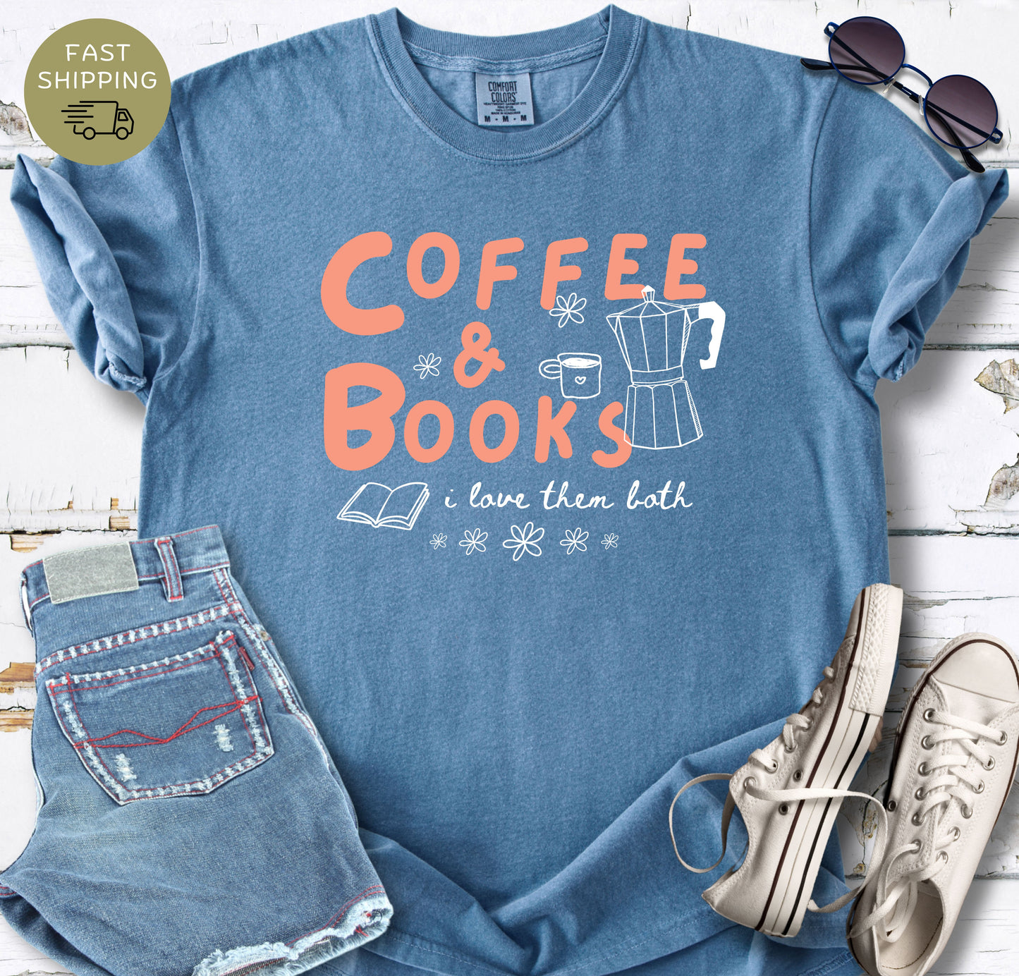 Women’s bookish T-shirt in blue jeans styled with denim shorts, sunglasses and white trainers.