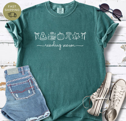 Reading season shirt styled with denim shorts, white trainers, and sunglasses.