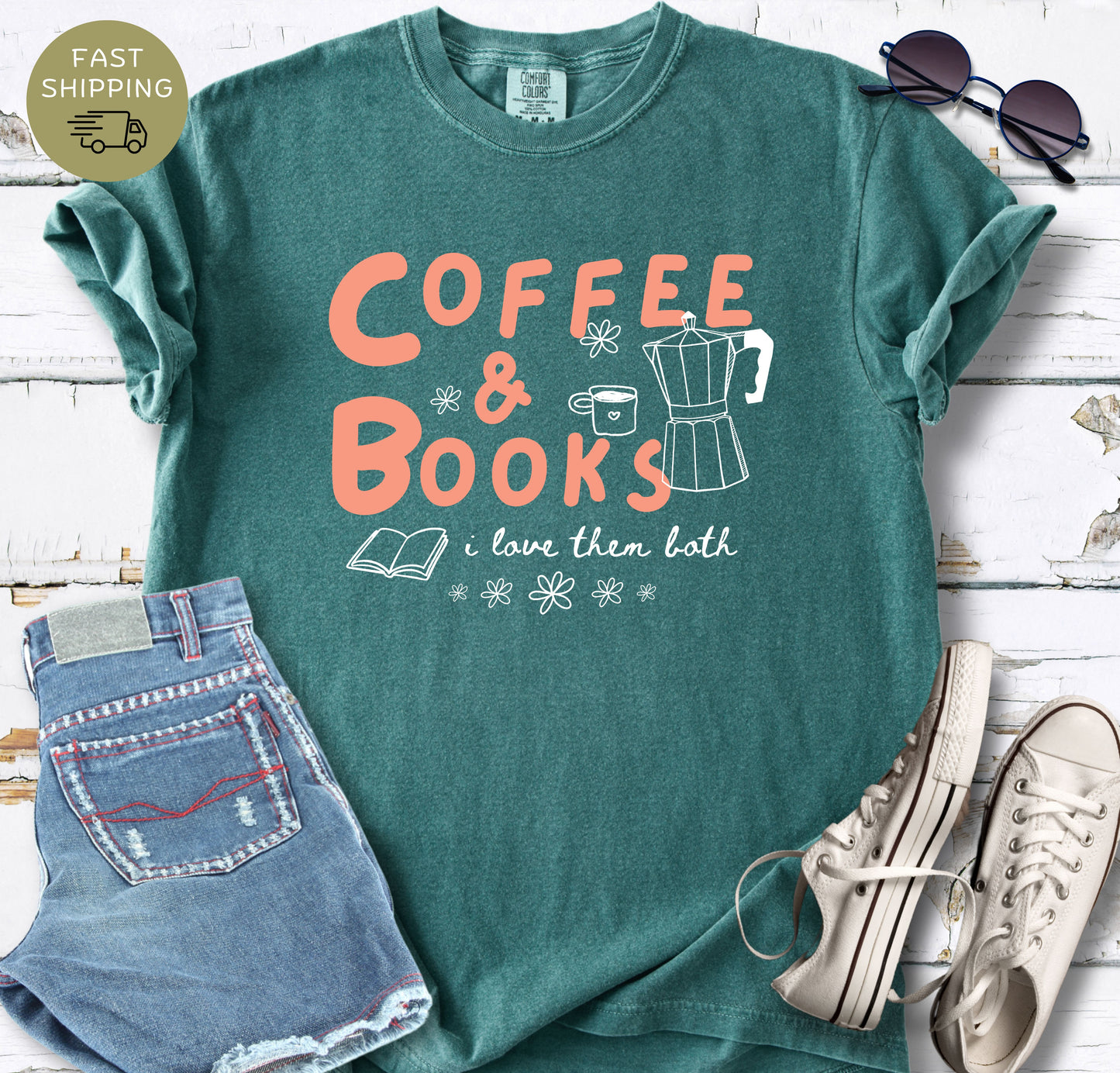Blue spruce garment-dyed graphic tee with coffee pot, coffee cup and book illustrations for book lovers.
