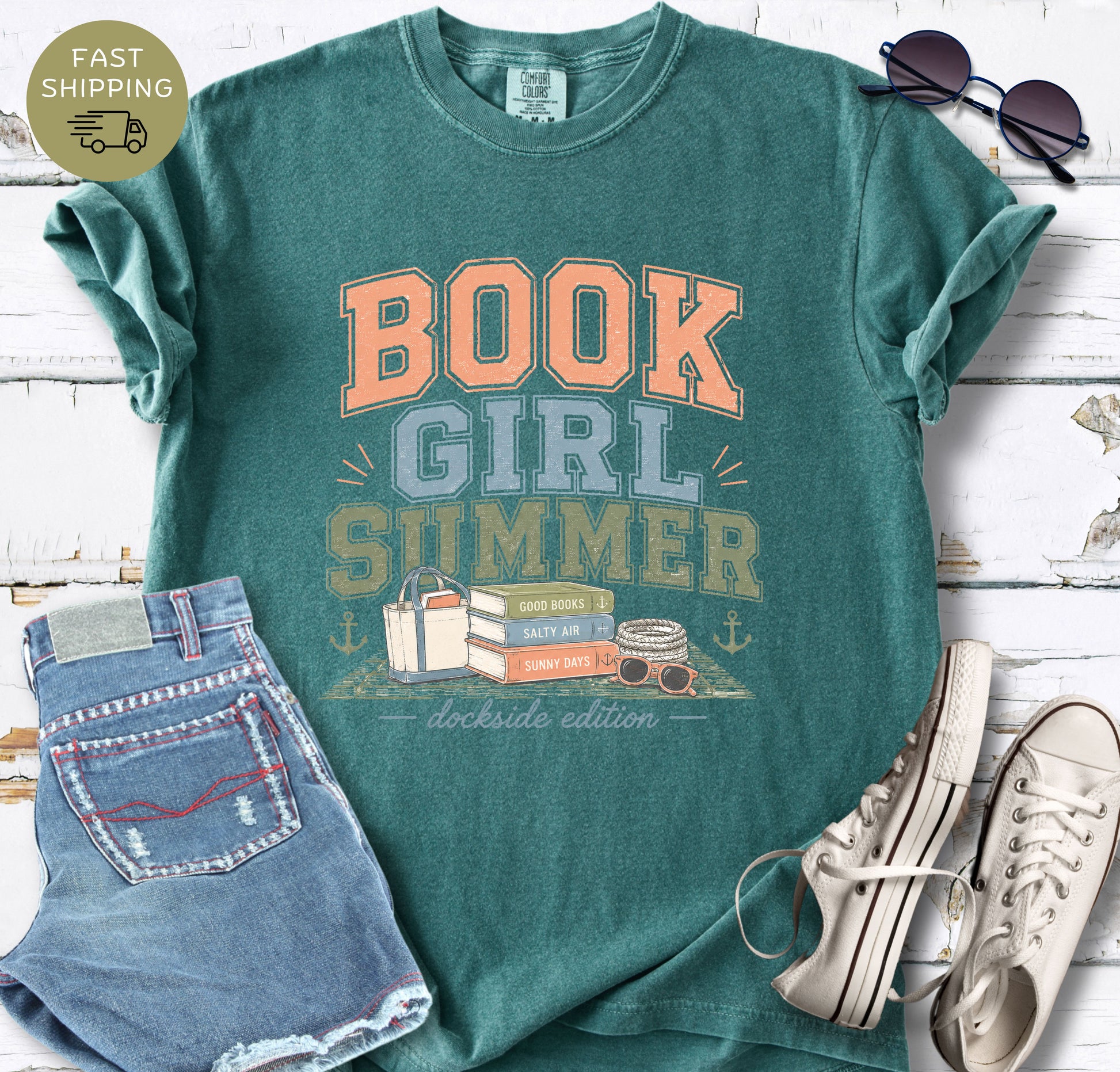 Summer book lover tee with beach aesthetic and stacked books illustration