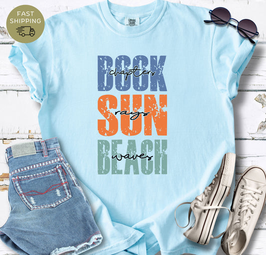 Chambray Comfort Colors t-shirt with “Book Sun Beach” coastal typography design