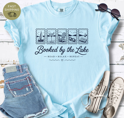 Chambray garment-dyed tee with a soft coastal lake reading design for book lovers.