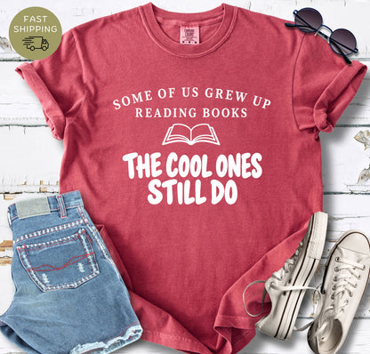 Crimson garment-dyed reader shirt with bold text design and simple open book illustration.
