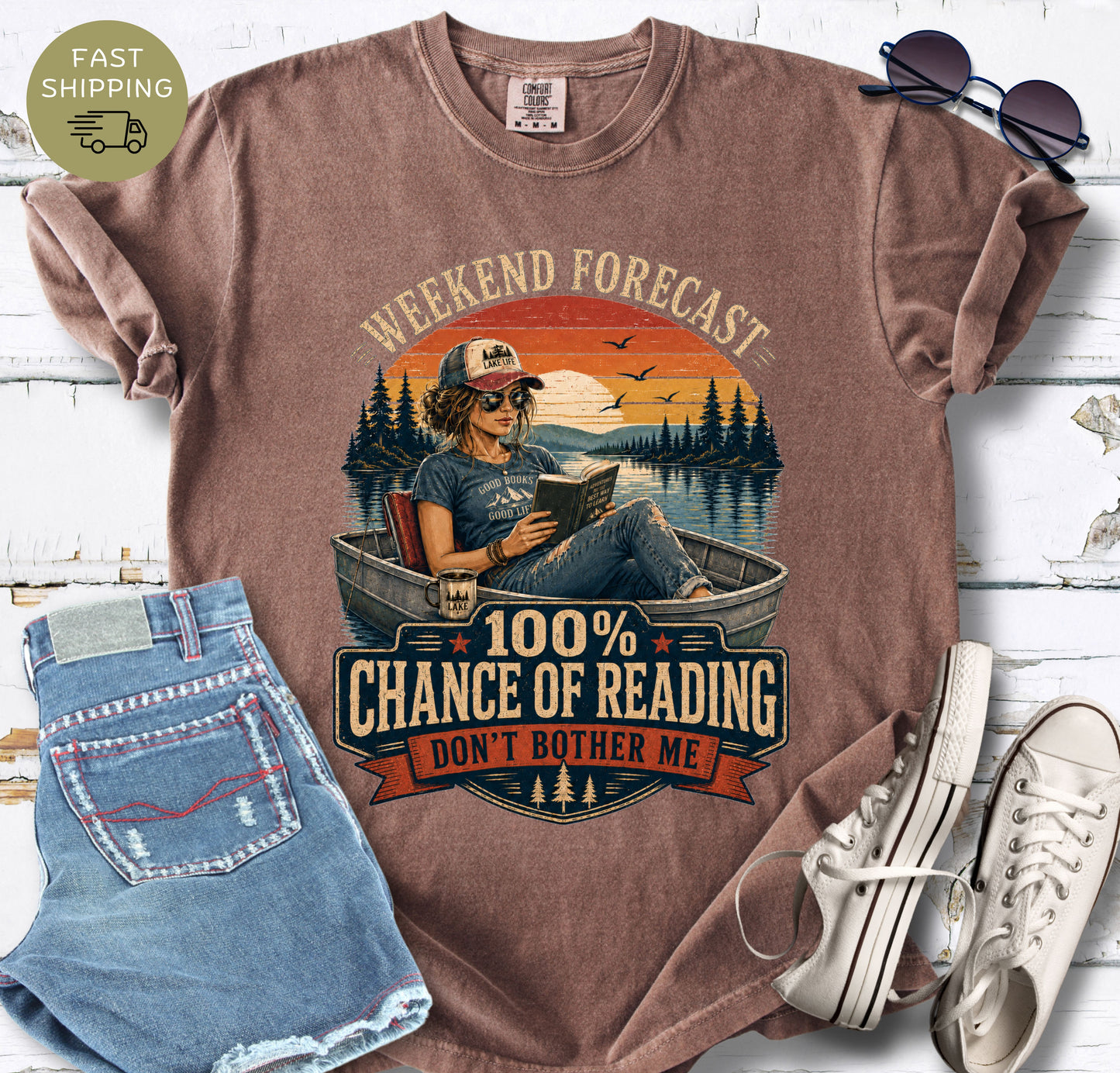 Vintage-inspired reader shirt with a boat, lake scene and bold “100% Chance of Reading” lettering.