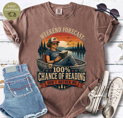 Vintage-inspired reader shirt with a boat, lake scene and bold “100% Chance of Reading” lettering.