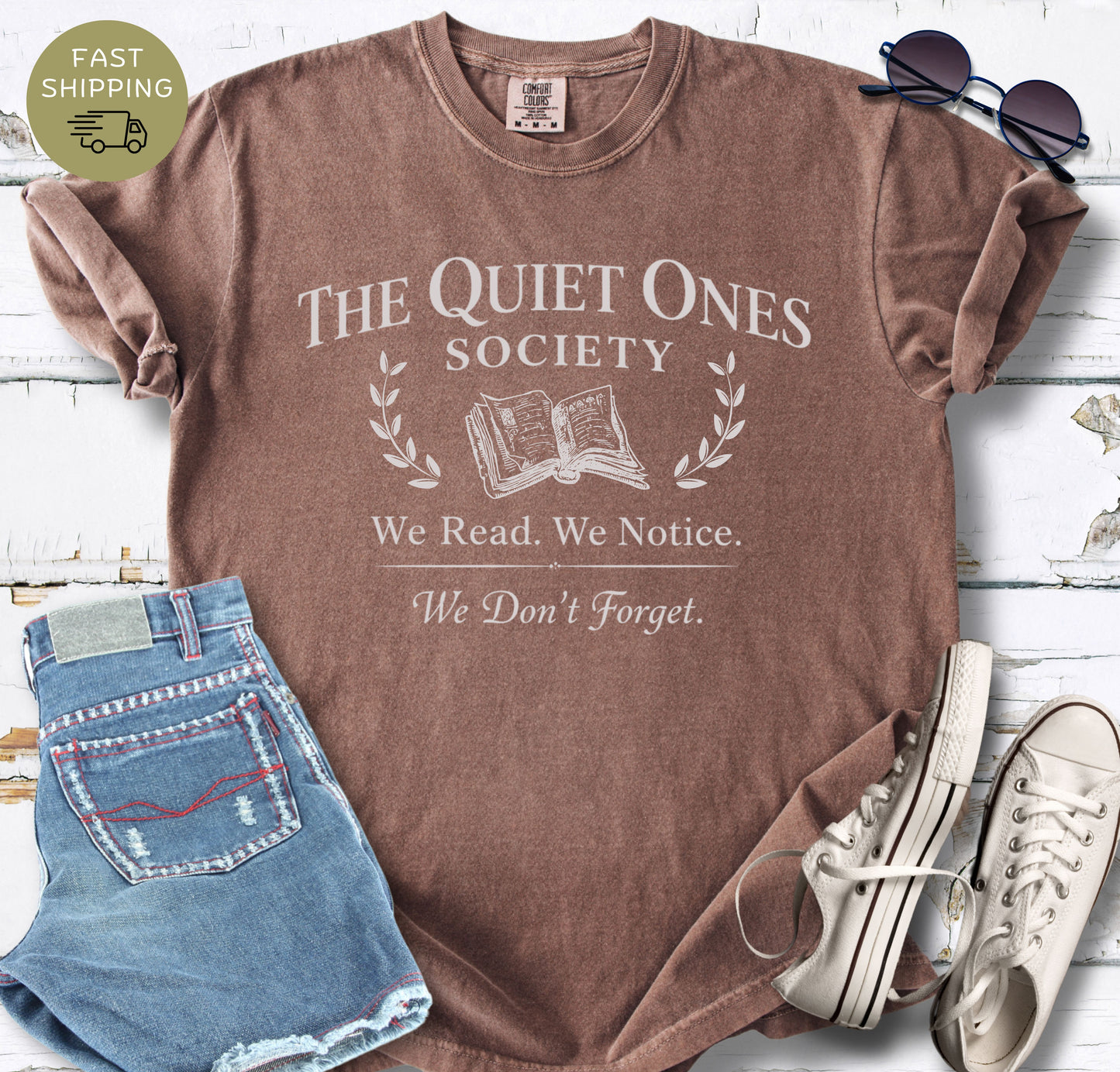 Minimalist book club t-shirt with vintage serif typography and open book icon