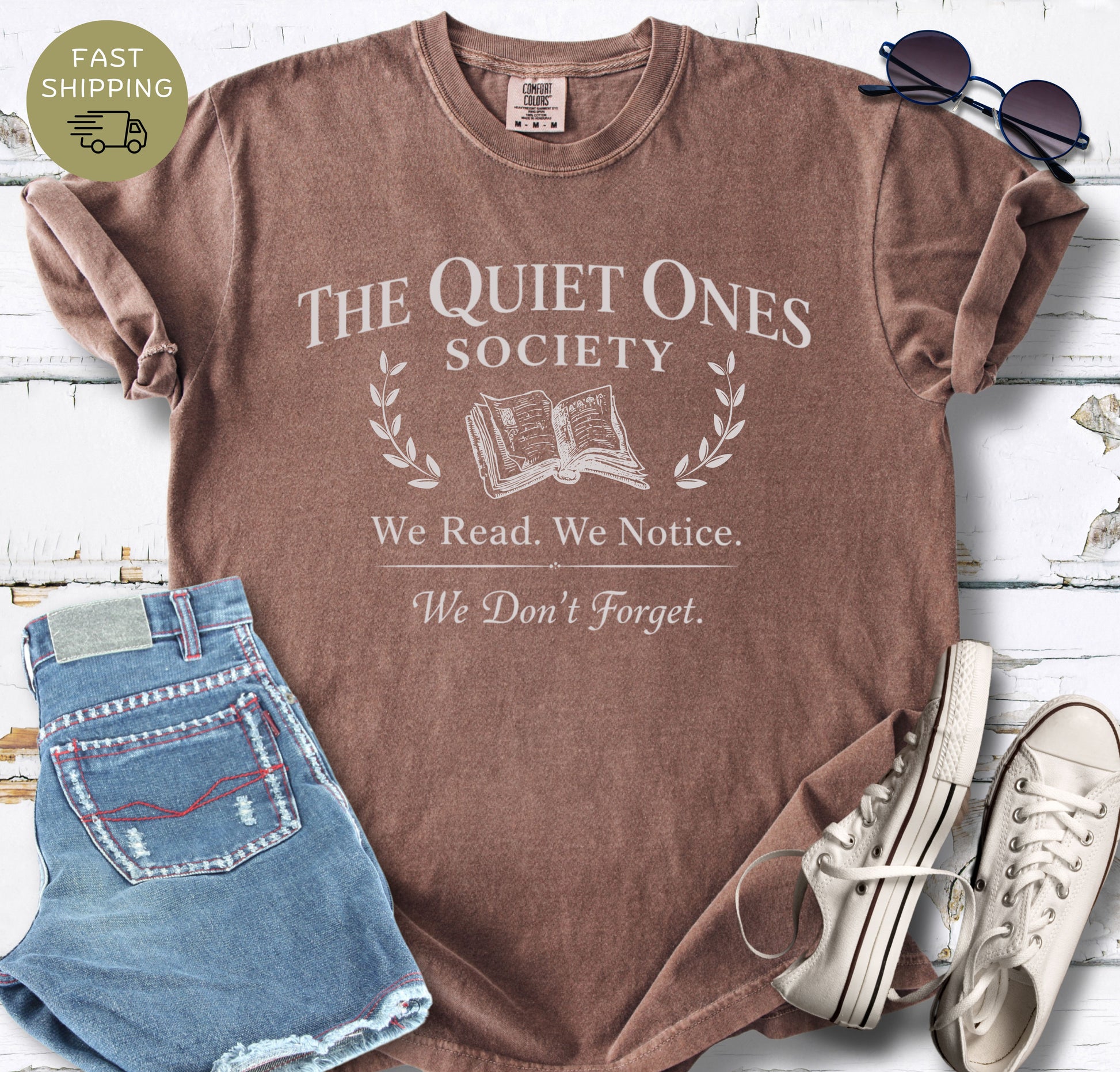 Minimalist book club t-shirt with vintage serif typography and open book icon