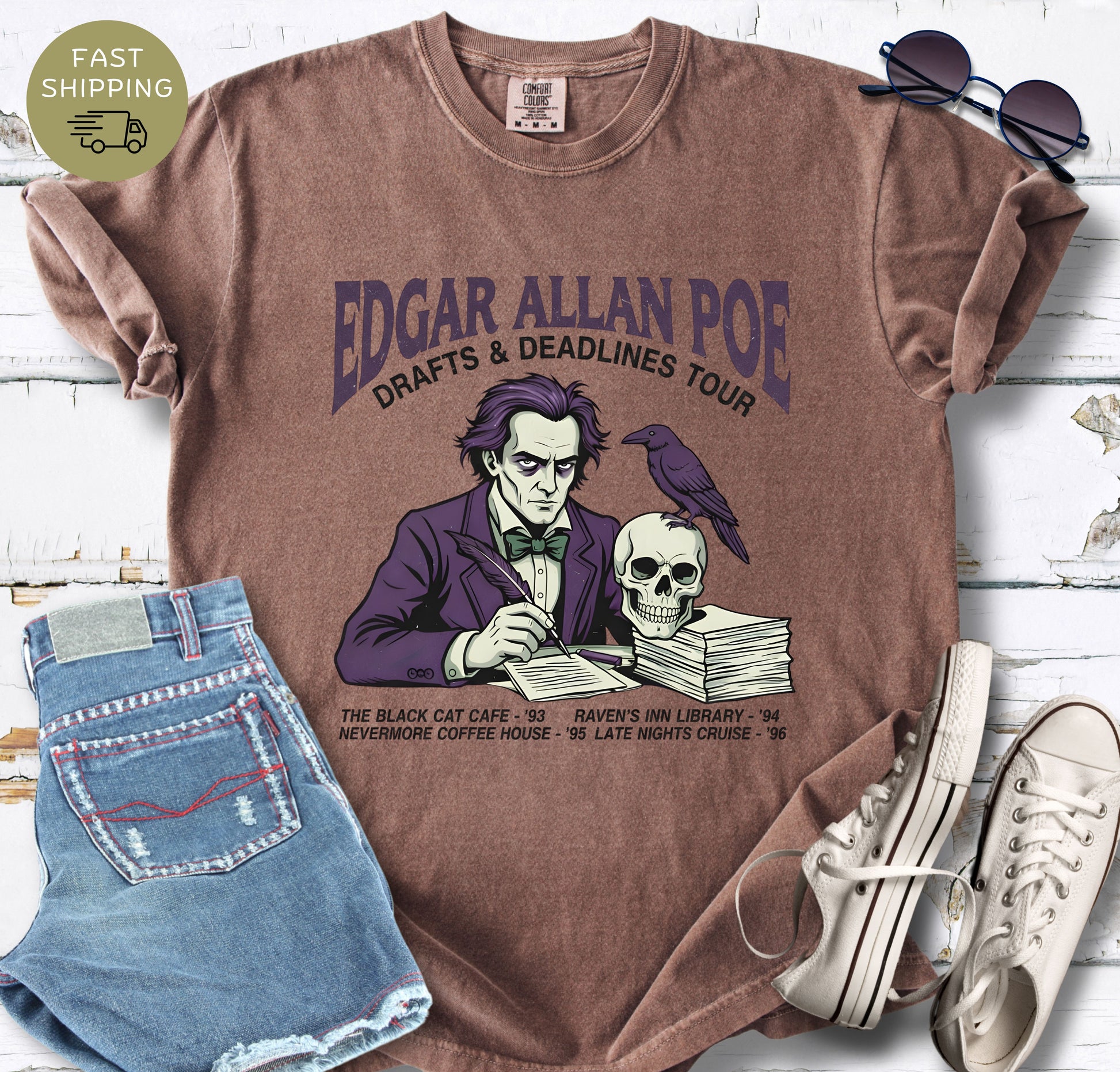 Espresso shirt with Illustrated Edgar Allan Poe wearing a purple suit, writing at a desk with a raven and skull, styled like a vintage literary tour t-shirt design.