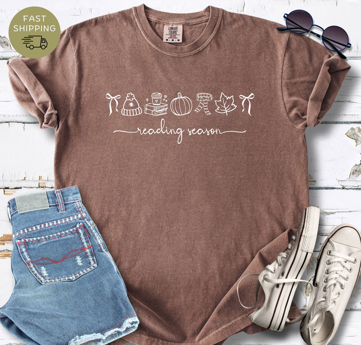Reading season graphic tee with cozy autumn symbols on an espresso garment-dyed shirt.