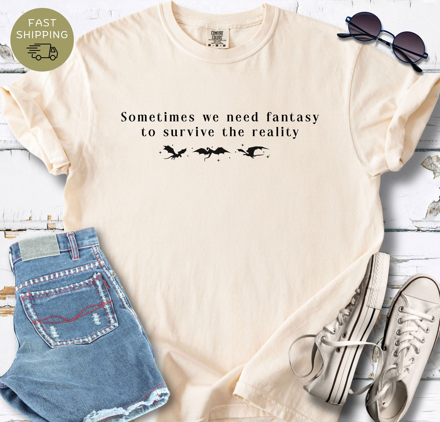 Ivory garment-dyed t-shirt styled with denim shorts, white trainers, and sunglasses.