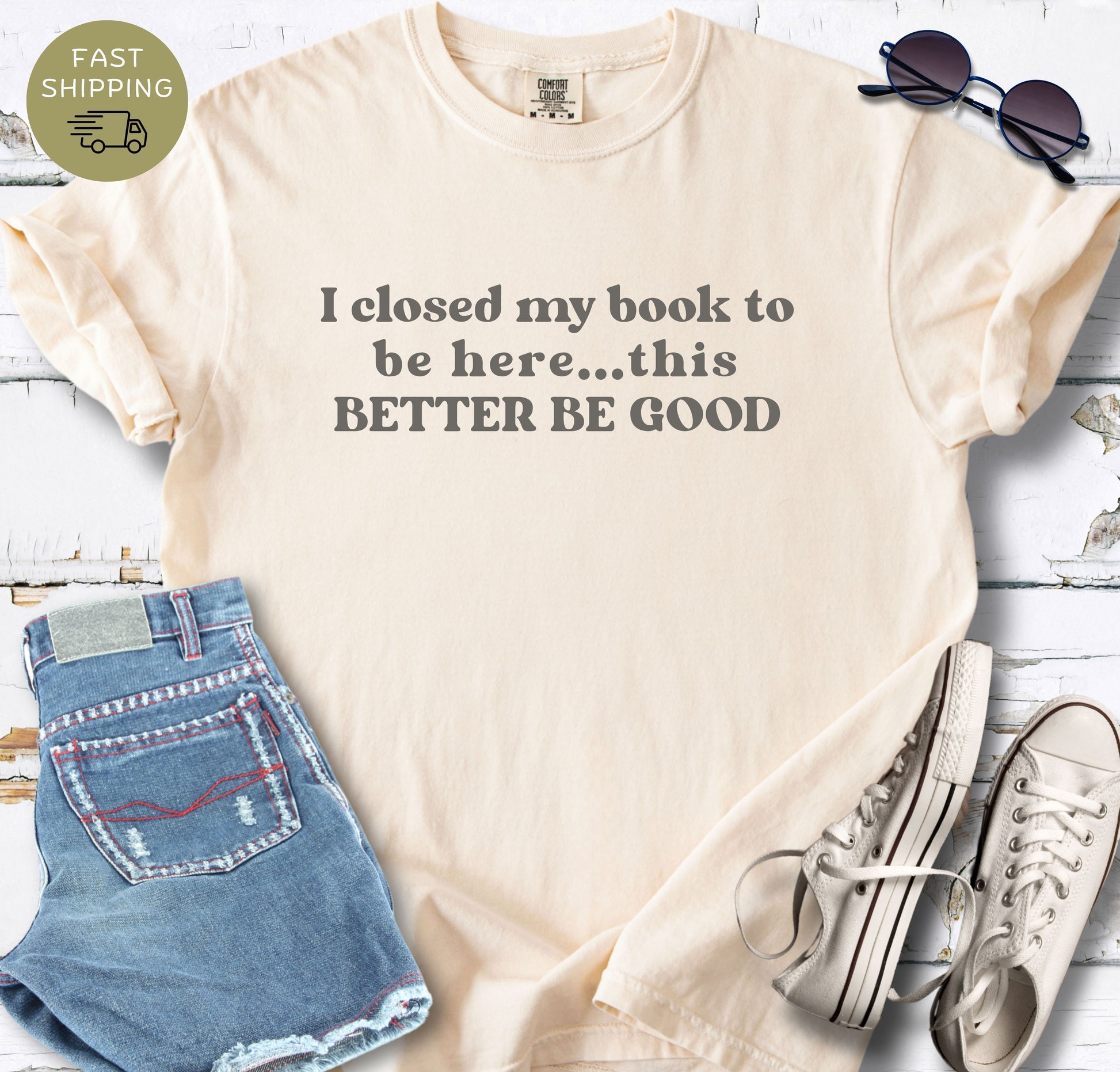 An Ivory bibliophile t-shirt designed for book lovers, shown in a lifestyle flat-lay. The shirt’s humorous text stands out against the rich [Color] fabric, perfect for library or coffee shop outings.