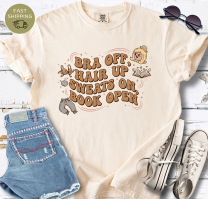 Ivory book lover shirt with bra off hair up sweats on book open quote