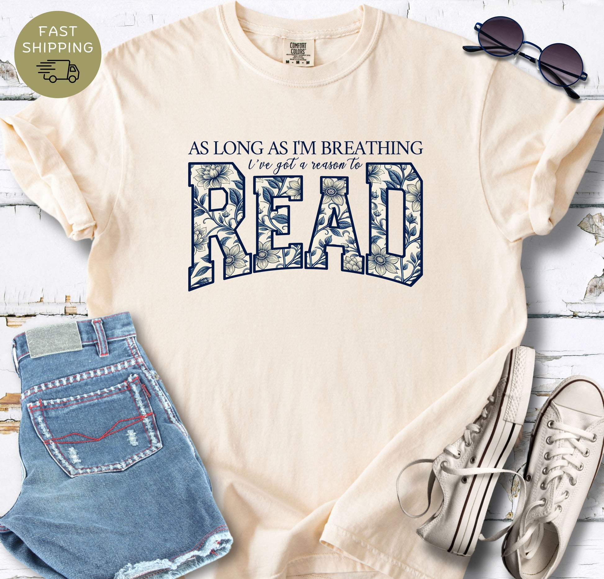 Ivory Comfort Colors bookish T-shirt featuring the quote As Long As I’m Breathing I’ve Got a Reason to Read.