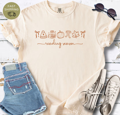 Ivory Comfort Colors t-shirt with rust line art icons and reading season text.