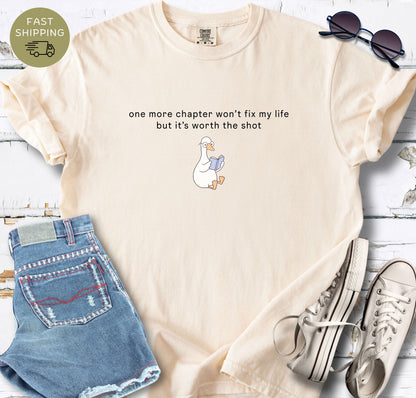 Comfort Colors 1717 Ivory t-shirt with “One more chapter won’t fix my life but it’s worth the shot” quote and cute reading duck illustration