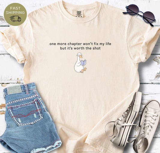 Comfort Colors 1717 Ivory t-shirt with “One more chapter won’t fix my life but it’s worth the shot” quote and cute reading duck illustration
