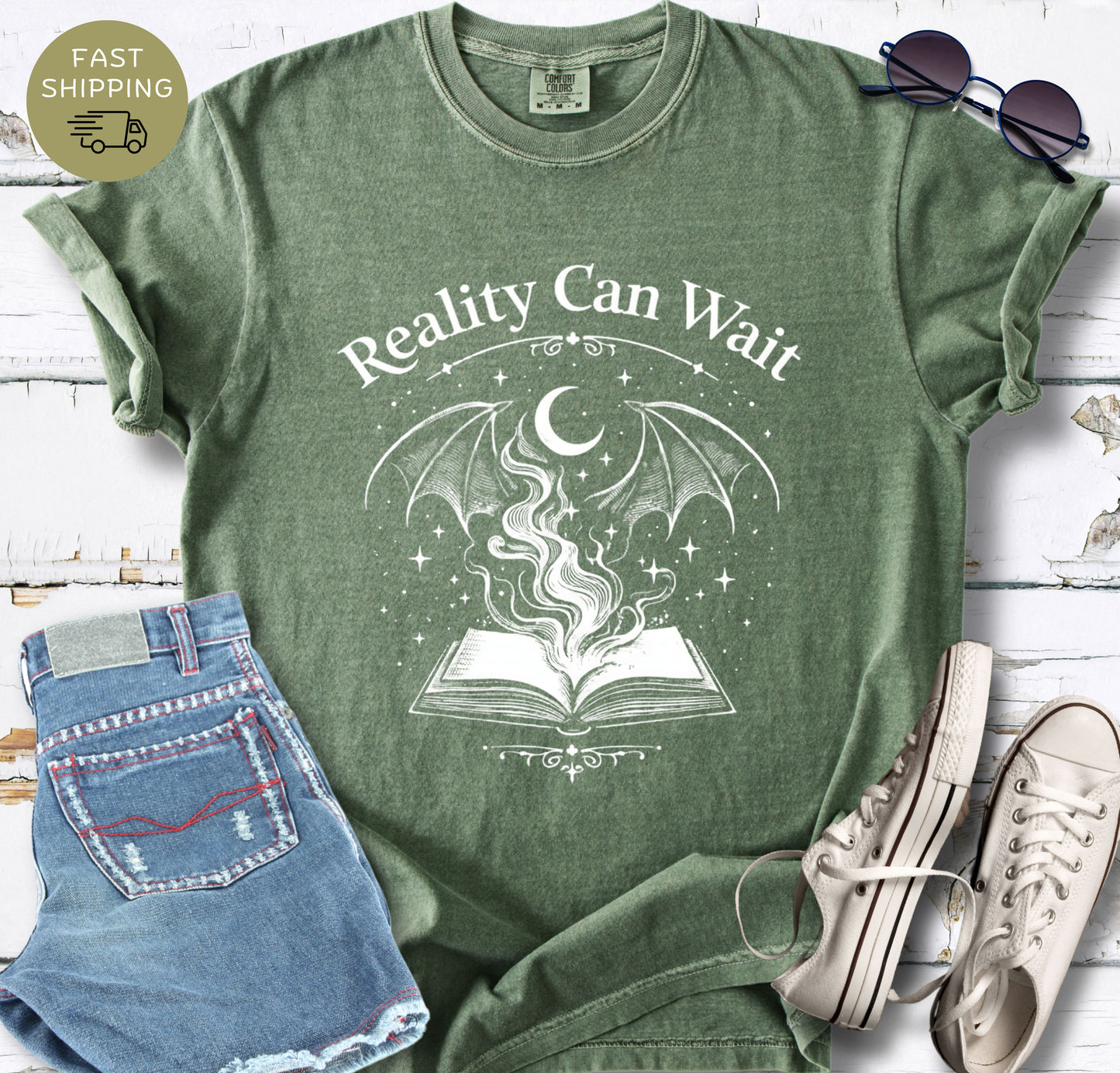 Reality Can Wait fantasy bookish t-shirt with open book and magical design on Comfort Colors 1717 moss