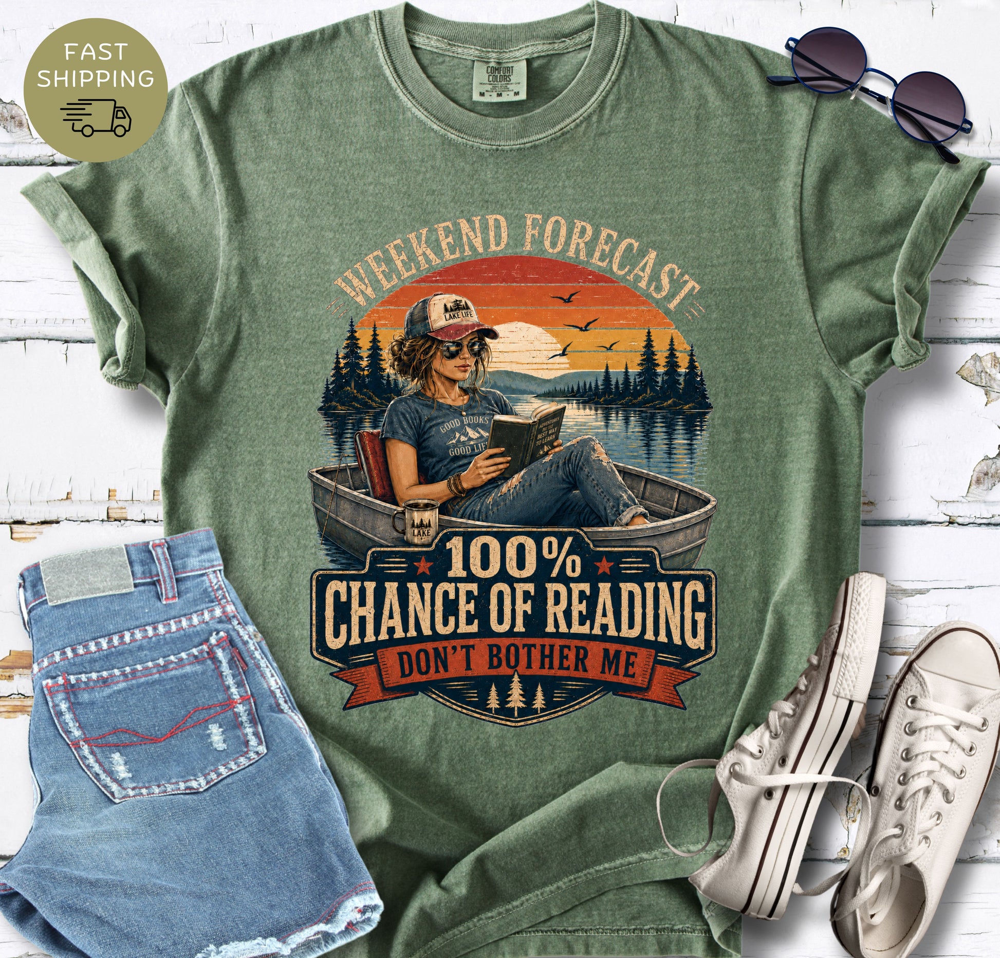 Lake life reading shirt with retro sunset stripes, pine trees, birds and a relaxed reader illustration.