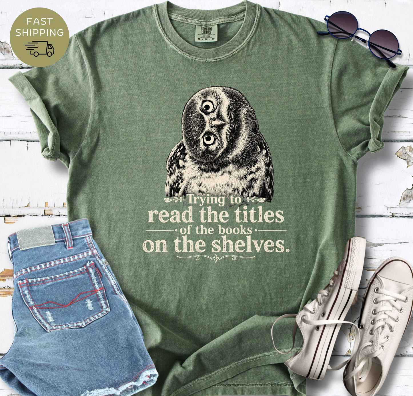 Women’s bookish T-shirt in dark grey styled with denim shorts, sunglasses and white trainers.