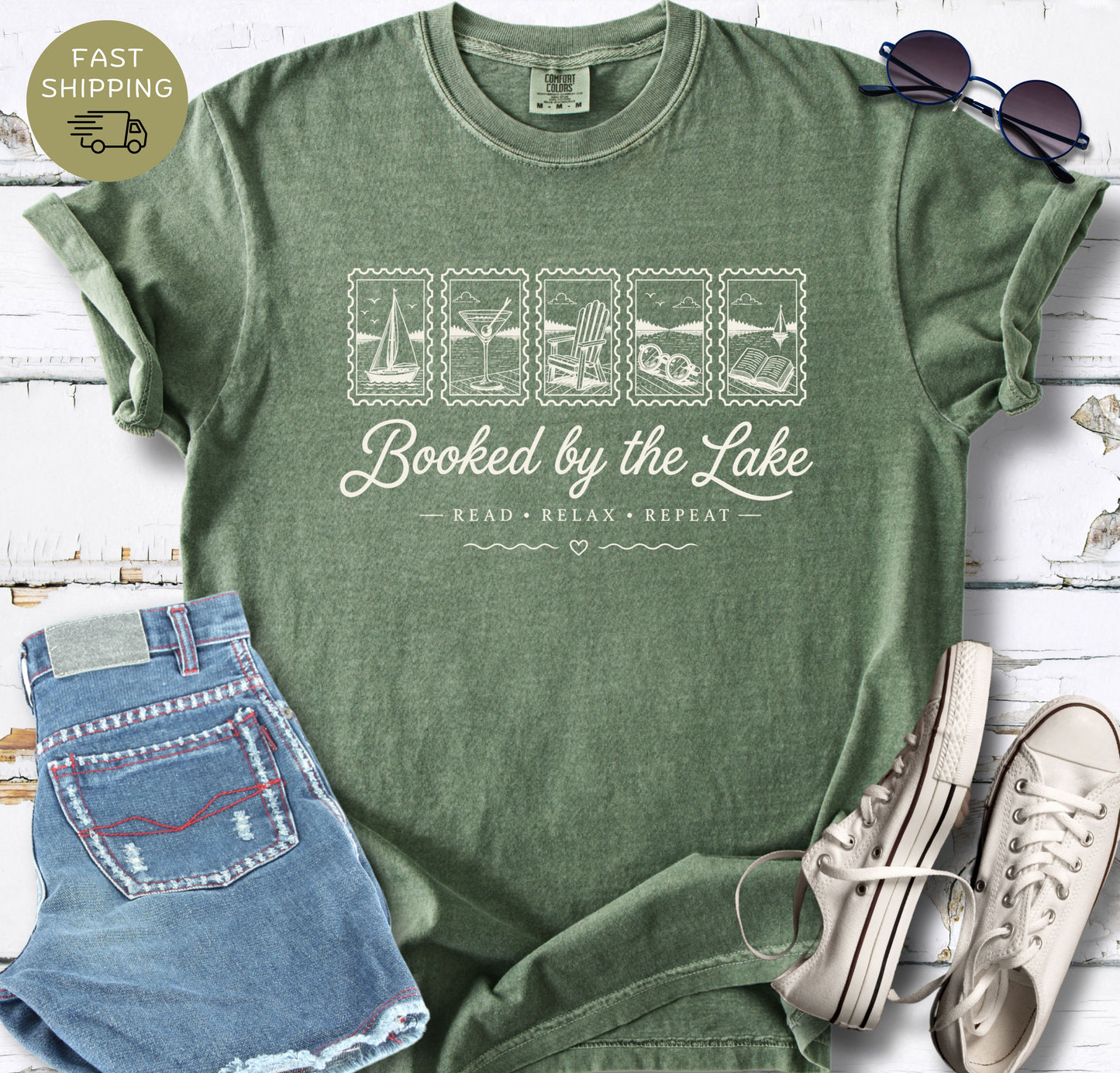 Comfort Colors reading shirt with a lake-inspired “Booked by the Lake” design in white lettering.