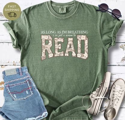 Women’s book lover graphic tee styled with denim shorts, sunglasses and white trainers.