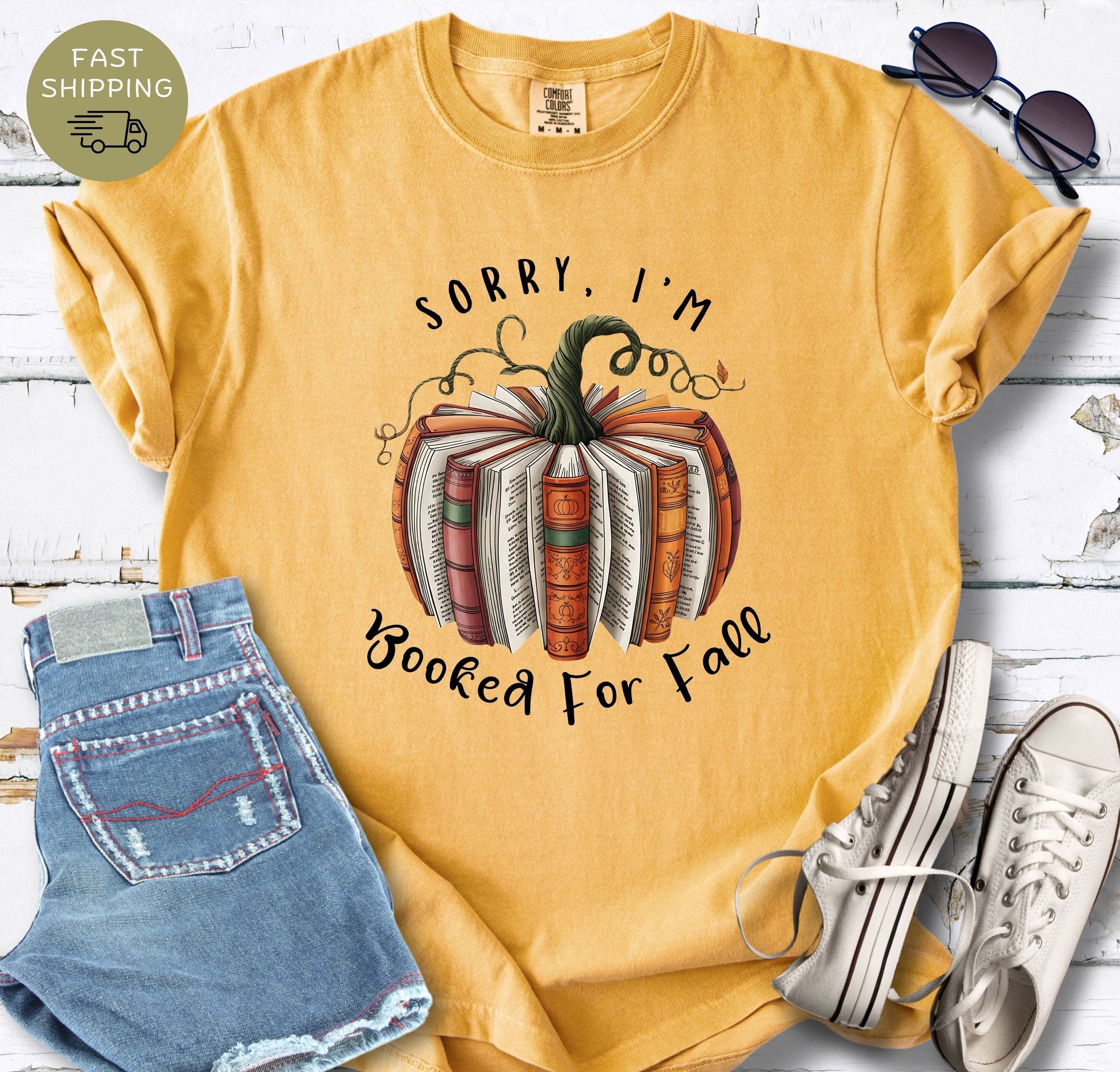 Comfort Colors mustard shirt with autumn book pumpkin design for book lovers.