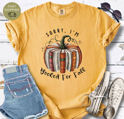 Comfort Colors mustard shirt with autumn book pumpkin design for book lovers.