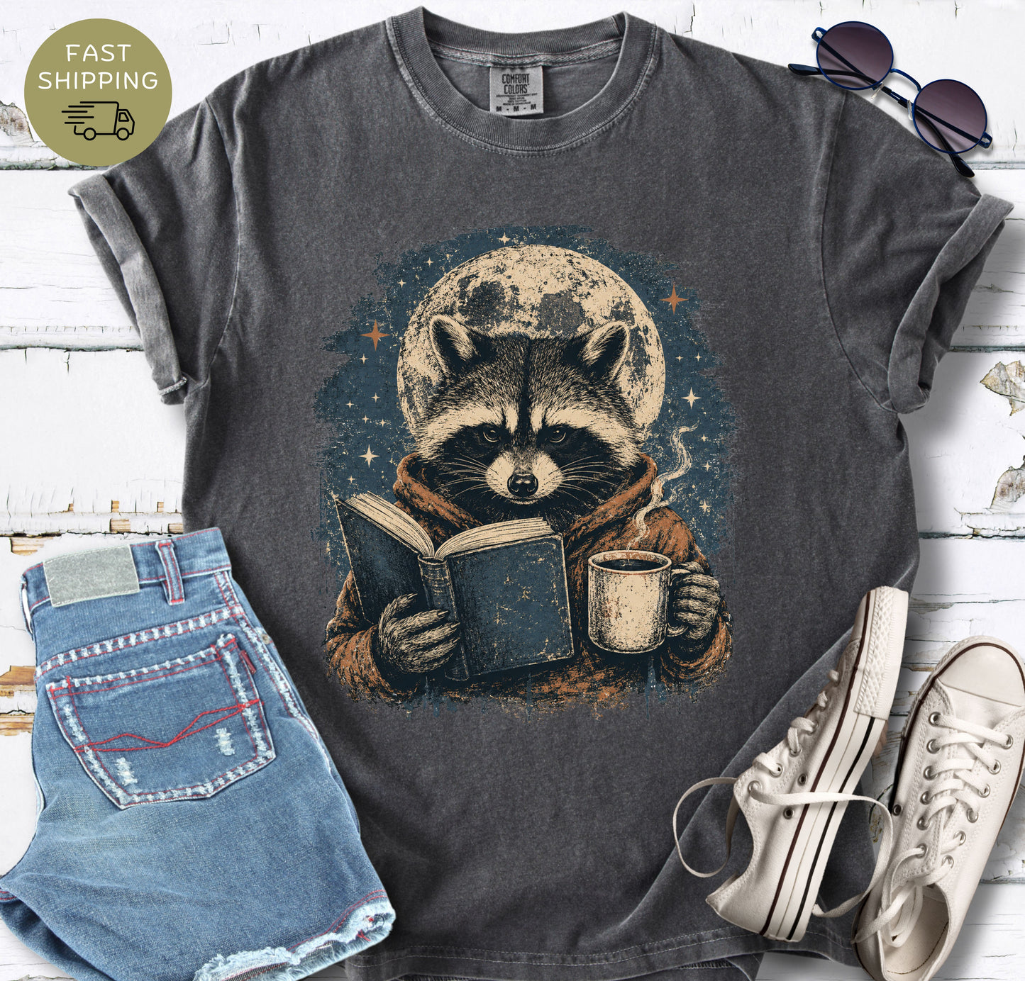 Bookish raccoon graphic tee with a hot drink, stars, and vintage distressed artwork.