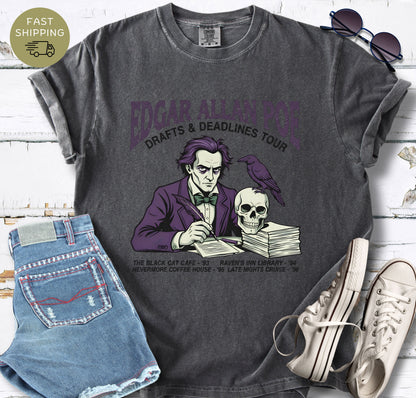 Pepper t-shirt with Illustrated Edgar Allan Poe wearing a purple suit, writing at a desk with a raven and skull, styled like a vintage literary tour t-shirt design.