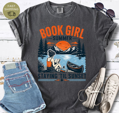 book lover tee featuring sunset, canoe, and reading girl illustration