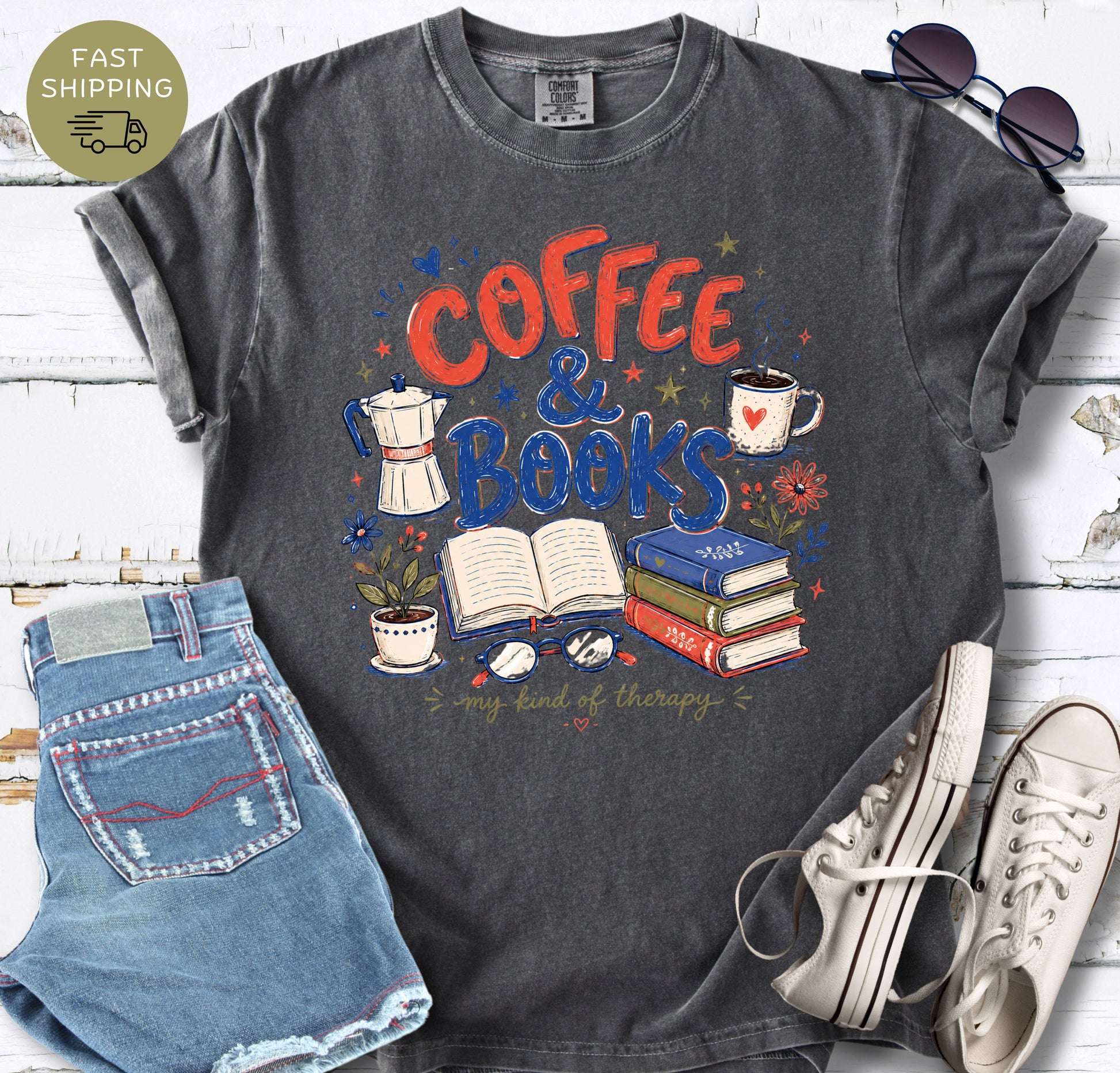 Book lover t-shirt featuring coffee cup, stacked books, open book, glasses, and flowers.