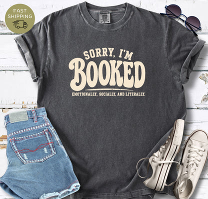Sorry I’m Booked Comfort Colors t-shirt in pepper with cream bookish text design.