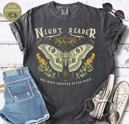 Pepper garment-dyed tee with “Night Reader” text and soft green, gold and black artwork.