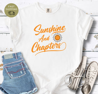 Retro reader apparel featuring a sun graphic and cursive text on a white  comfort colors shirt.
