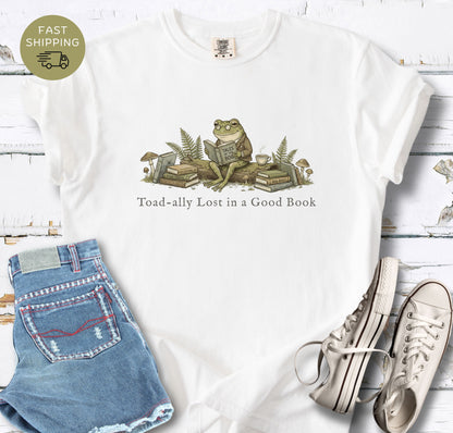 Bibliophile shirt featuring frog sitting with books and mushrooms