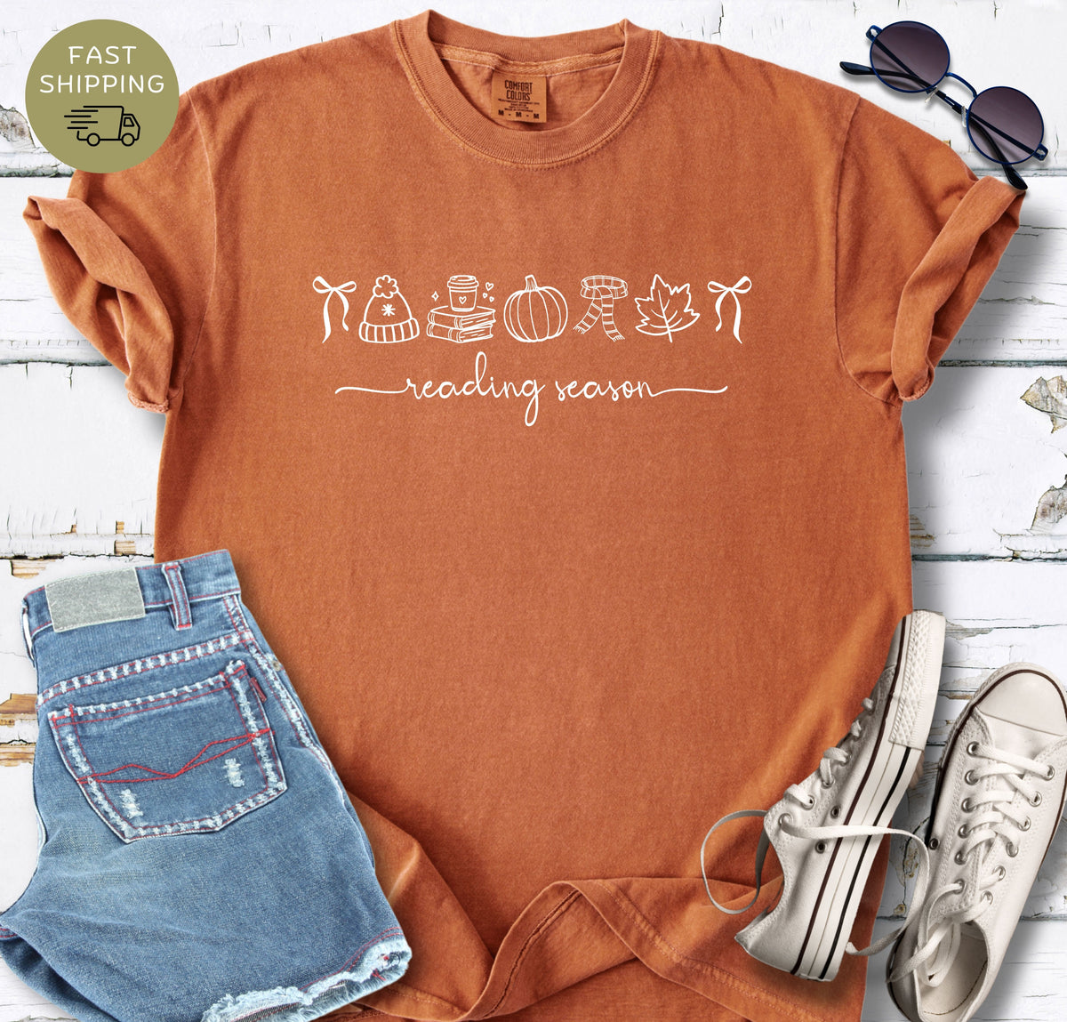 Minimal bookish fall shirt featuring books, coffee, pumpkin, scarf, leaf, and beanie icons.