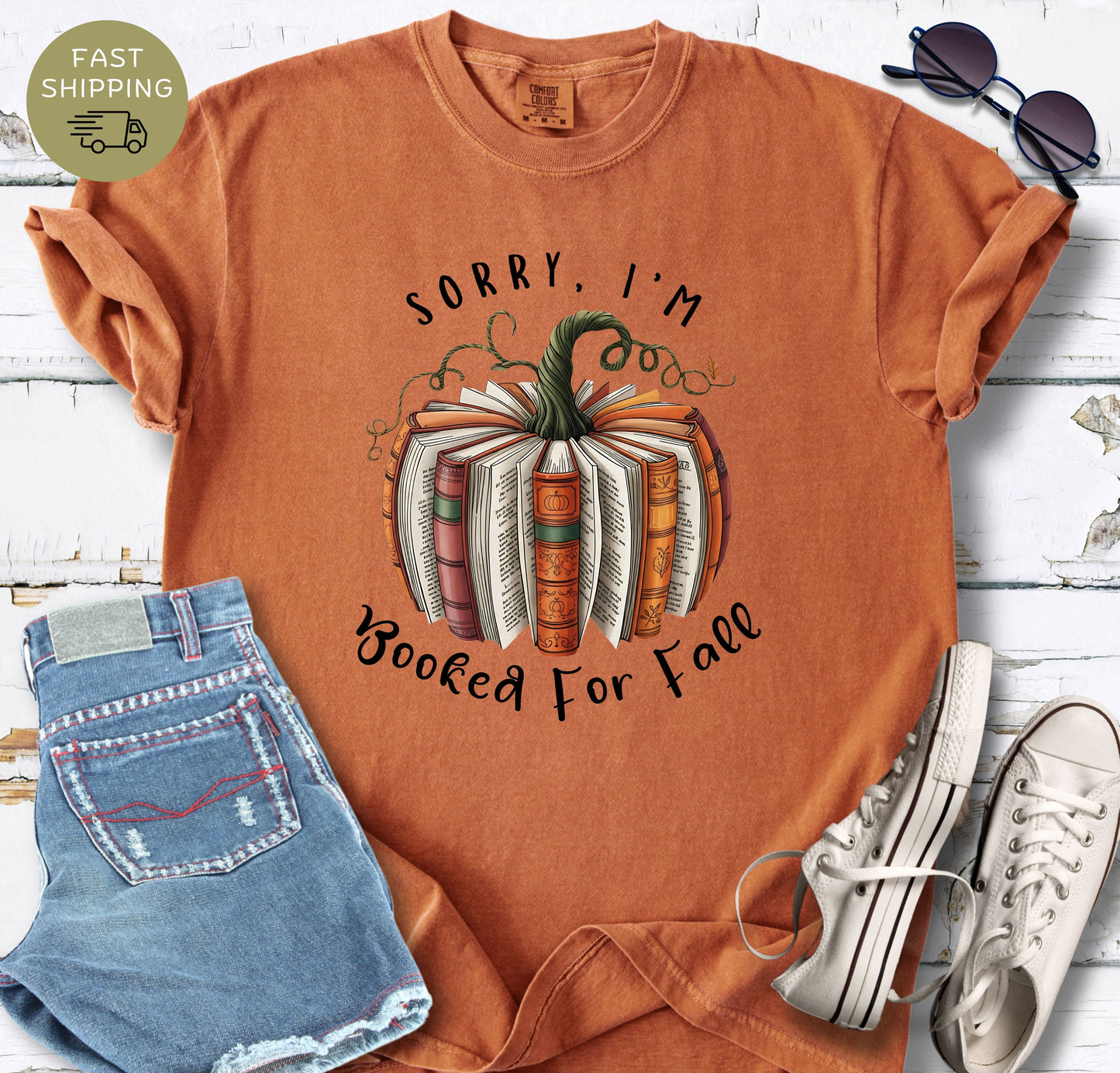 Fall book lover shirt featuring a pumpkin made from open books and autumn vines.