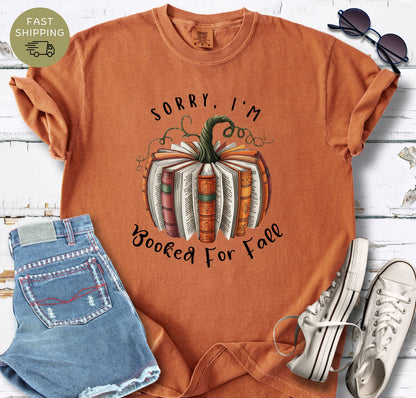 Fall book lover shirt featuring a pumpkin made from open books and autumn vines.